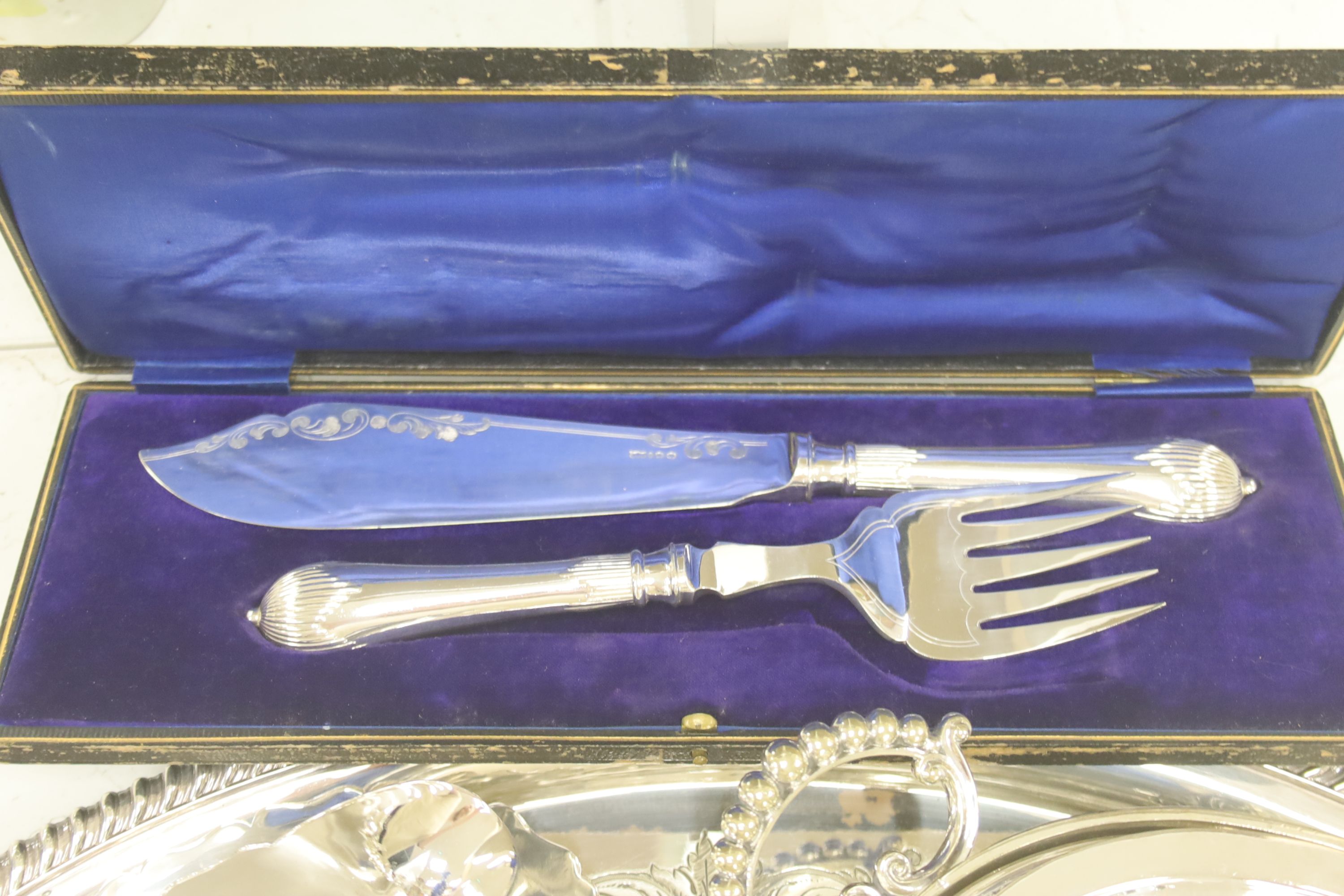 A collection of silver-plated wares to include an oval drinks tray, a cocktail shaker, serving tureens, etc.